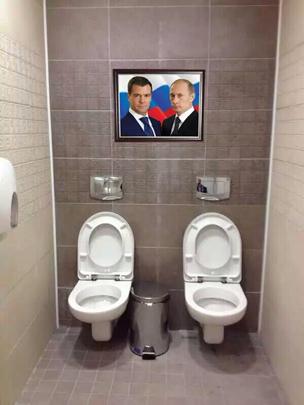 Putin and Medvedev above the double toilets