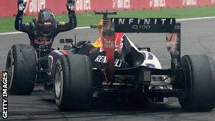 Sebastian Vettel celebrates with his Red Bull car