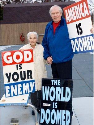 Phelps, shown with his wife and some of his signs, in 2007
