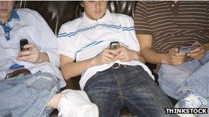 Teenagers using mobile phones