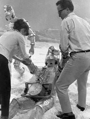 director, Derek Martinus, and his Production Assistant, Edwina Verner, give a helping hand to one of the Cybermen filming The Tenth Planet