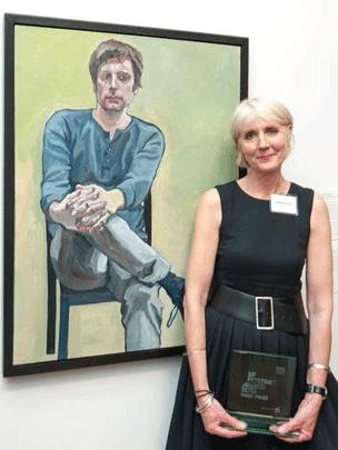 Susanne du Toit in front of her portrait of her son Pieter, which won the 2013 BP Portrait Prize