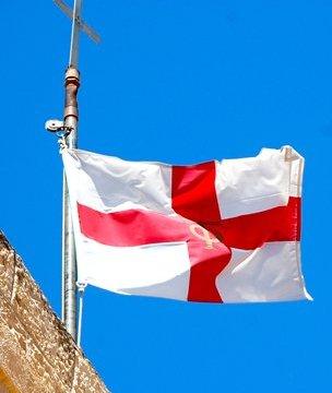 The flag of St George flying against a blue sky