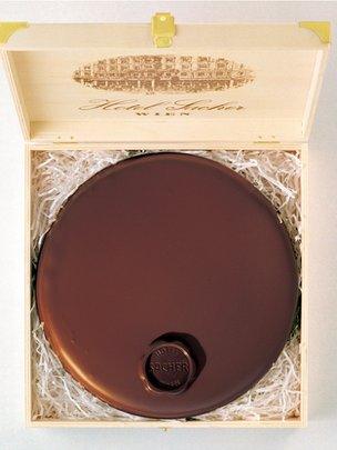 A sachertorte from Hotel Sacher being boxed for sale