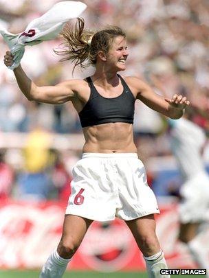 Brandi Chastain holding her shirt in the air