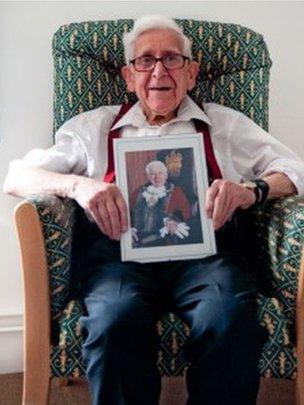 Bernard Jordan with a photo of himself as mayor