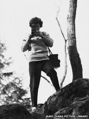 Shirley Baker taking a picture with her Rolliflex camera