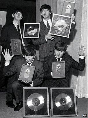 The Beatles with a hoard of silver discs in 1963