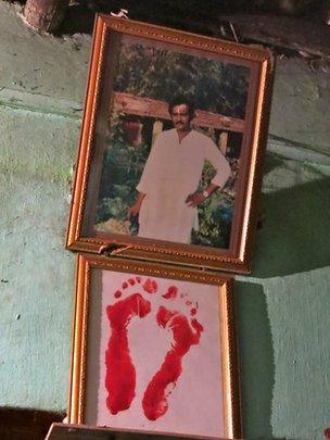 Portrait and footprints of Sunil Mandal, Gita's late husband