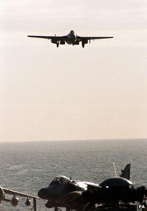 A De Havilland Vampire jet lines up for its landing on the deck of HMS Illustrious, as it recreates the first landing, 50 years ago, by a jet aircraft on an aircraft carrier.
