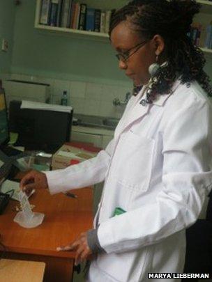 Pharmacist Mercy Maina running test cards at the Moi Teaching and Referral Hospital in Eldoret, Kenya