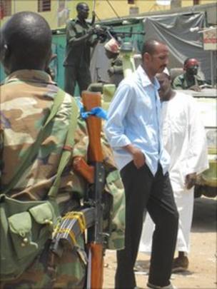 soldier with gun at market