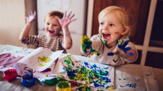 Children painting on kitchen table