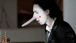 A person wears a costume at a cafeteria during the pop culture exhibition MCM Comic Con at London's ExCel centre, on 24 October 2021