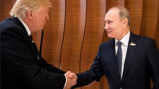 US President Donald Trump and Russia's President Vladimir Putin shake hands during the G20 Summit in Hamburg, Germany, 7 July 2017