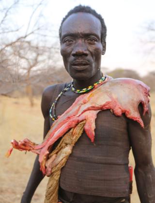 Hadza com pedaço de carne crua
