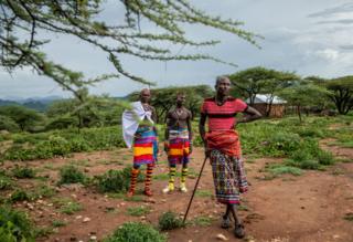 in_pictures Two Samburu warriors talk to Tiampati Leletit, who lost 80 of his goats when the locusts arrived