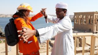 Spanish actress Victoria Abril dancing with a man at the Temple of Philae in Aswan, Egypt - Tuesday 11 February 2020