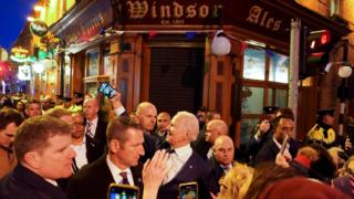 Joe Biden takes a selfie outside a pub in County Louth as hundreds of people surround him