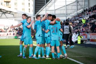 Newcastle players celebrate at Brentford