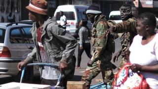 Soldiers gesturing to people in Harare, Zimbabwe - 2 August 2018
