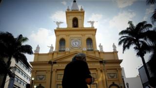A woman walks in front of the Metropolitan Cathedral after a shooting, in Campinas, Sao Paulo state, Brazil, 11 December 2018