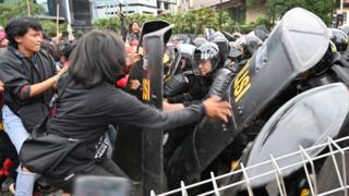 Indonesian activists clash with police during a protest to mark May Day