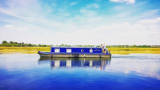 A canal boat on the Thames at Port Meadow