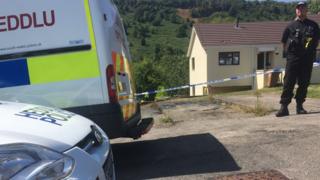 Police officers have put a cordon around the house