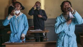 Students at Antananarivo school drinking Covid-Organics