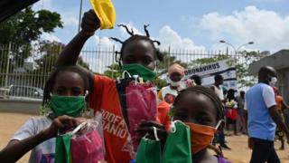 Crianças vendendo máscaras na Costa do Marfim