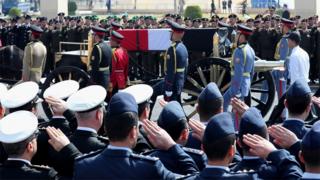 Egyptian military personnel salute a horse-drawn carriage transporting the coffin of Hosni Mubarak at the Tantawi mosque in Cairo (26 February 2020)