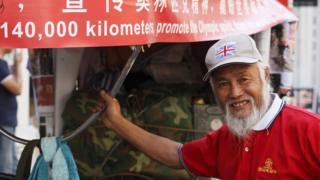 Chen Guanming, 57, a Chinese farmer who has spent two years riding nearly 40,000 miles (60,000 kilometers) through 16 countries on a rickshaw to reach London in time for the 2012 London Olympic Games, is pictured July 26 2012 in London.