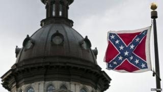 A Confederate flag flies outside the South Carolina State House in Columbia, South Carolina in a January 17, 2012