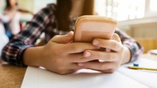 Teenager using smartphone