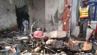 Pakistani rescue workers search the site of a suicide bomb attack on the outskirts of Peshawar (19 January 2016)