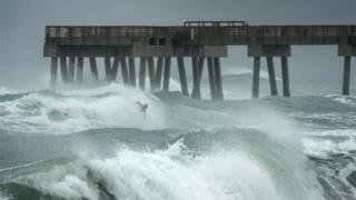 Surfer in Juno Beach, Florida as Isaias approaches