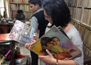 Anu looking at records