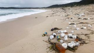 Small plastic containers litter beach near Port Stephens in New South Wales