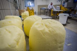 Large balls of butter on a worktop in a dairy