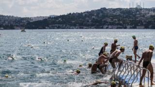 Swimmers reach the finishing line