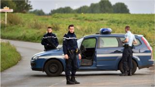 Gendarmes block a road near a Roma camp in Roye