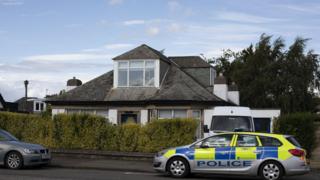 Police searching a house in Edinburgh after a man is arrested at Heathrow Airport