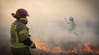 Firefighter attacks flames in Poland