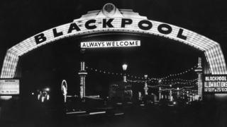A black and white photo of an arch saying Blackpool