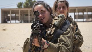 Female Israeli soldiers practise shooting on 6 July 2016 in Nitzana, Israel