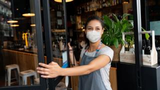A cafe worker wearing a mask