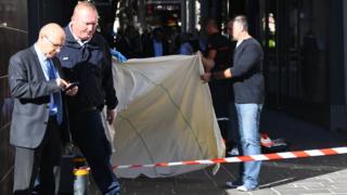Forensics work on the site where Pascal Filoe, head of the municipal police, was stabbed to death in Rodez, southern France