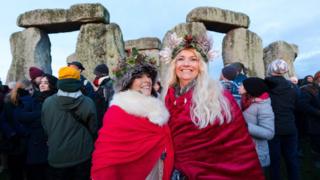 Revellers take part in the winter solstice celebrations at the ancient Stonehenge monument in Wiltshire, Britain, 22 December 2019.