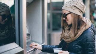 Young woman at ATM